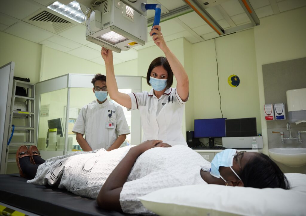 Diagnostic Radiographers with a patient in a hospital