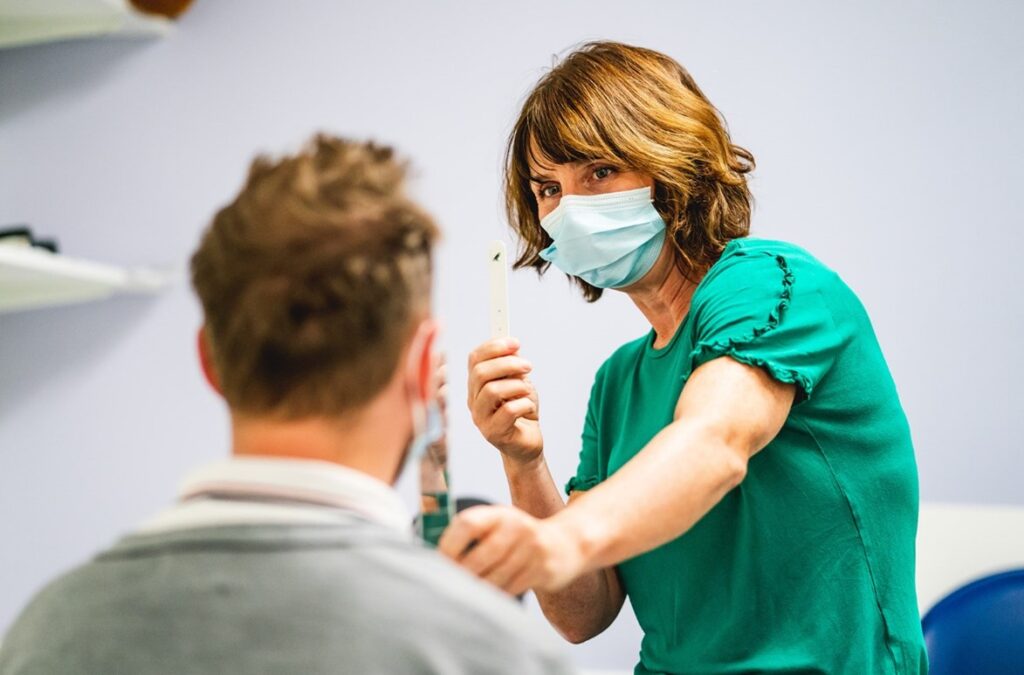 an orthoptist assessing a patient's eyes