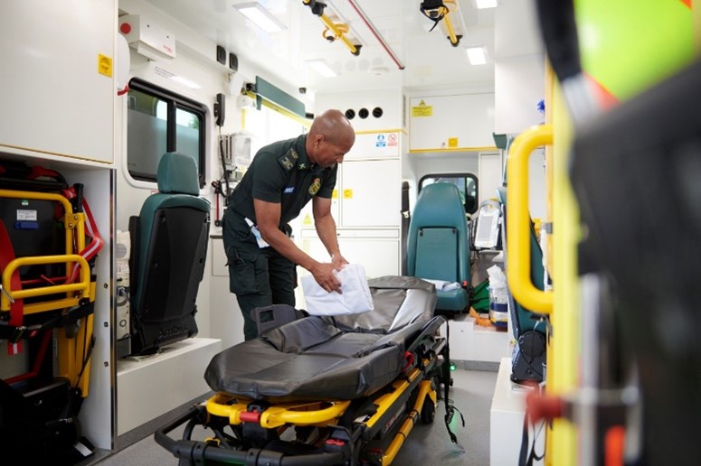 paramedic cleaning an ambulance