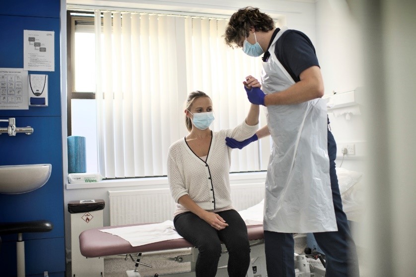 a physiotherapist assessing a patient's arm