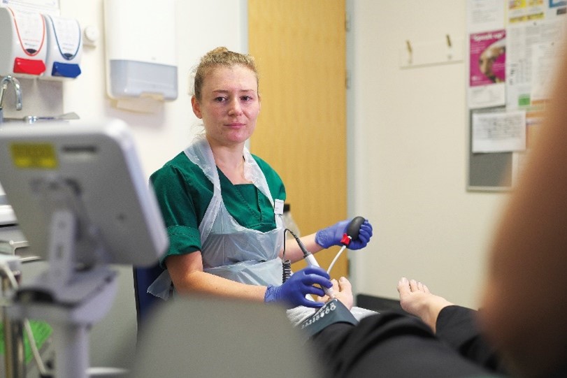 podiatrist assessing a patient